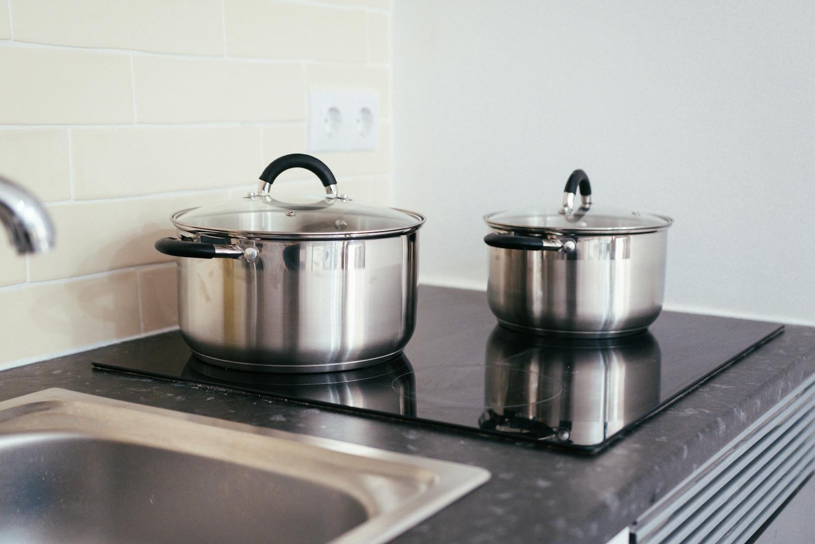 Stainless steel cookware on a modern induction cooktop