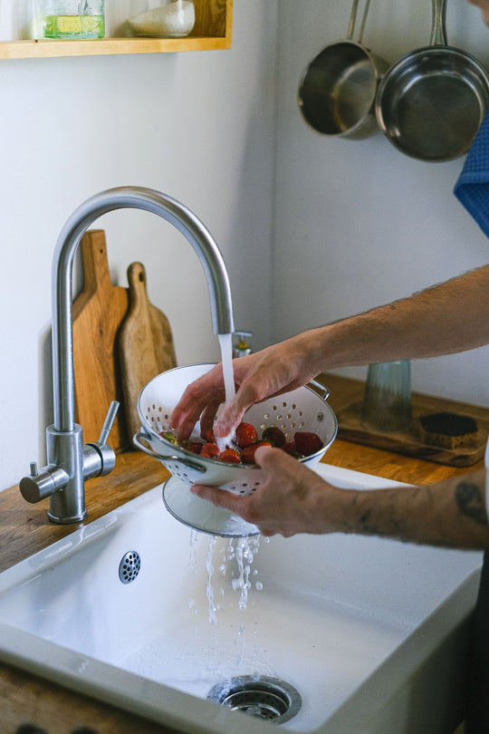 Over-the-Sink Expandable Cutting Board with Built-In Colander — colander over kitchen sink